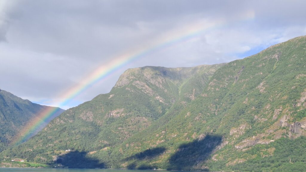 Image of a rainbow over a mountain.